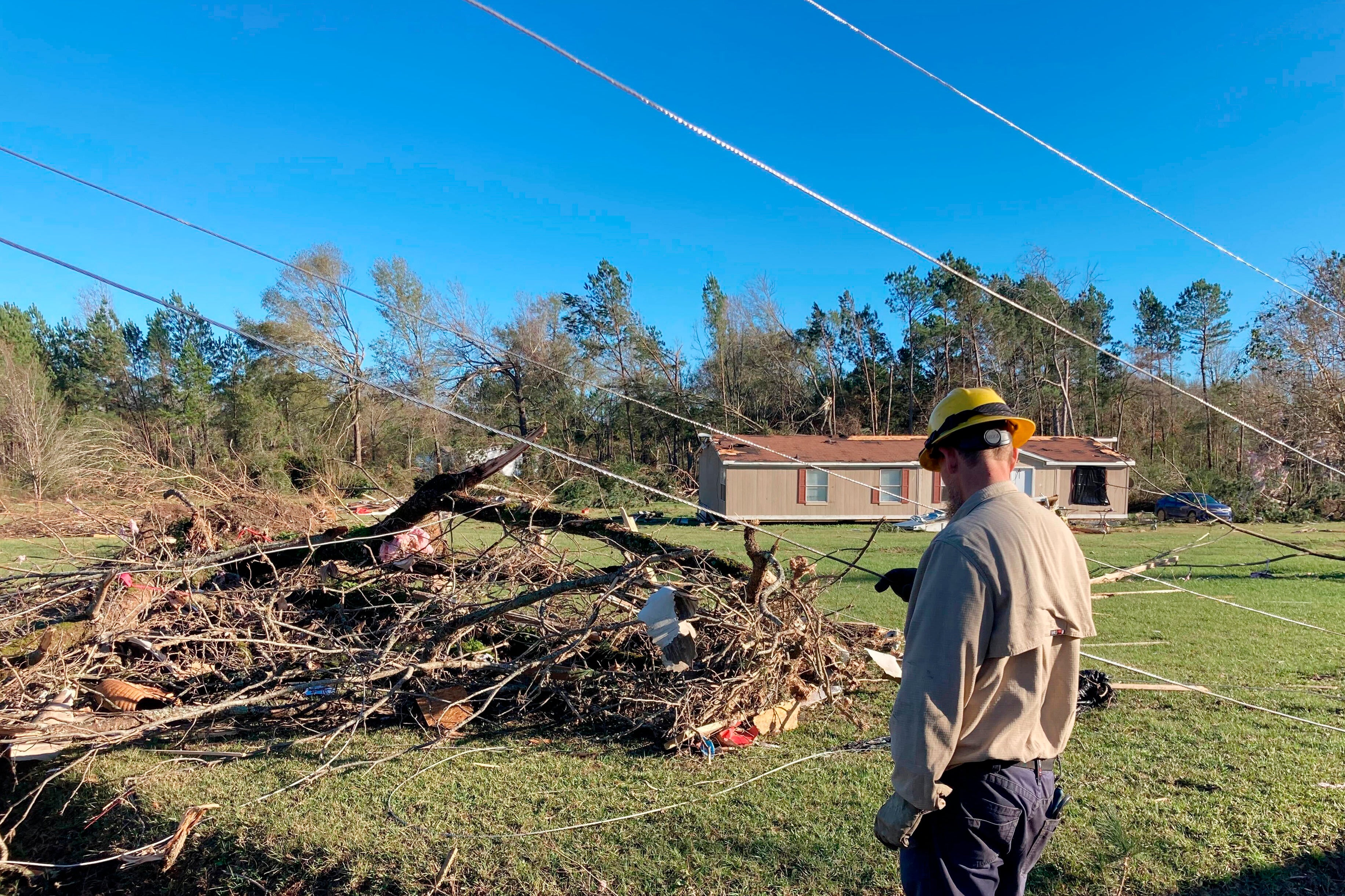 A utility worker observes damage in Keithville, Louisiana.  (Photo: Jake Bleiberg, AP)