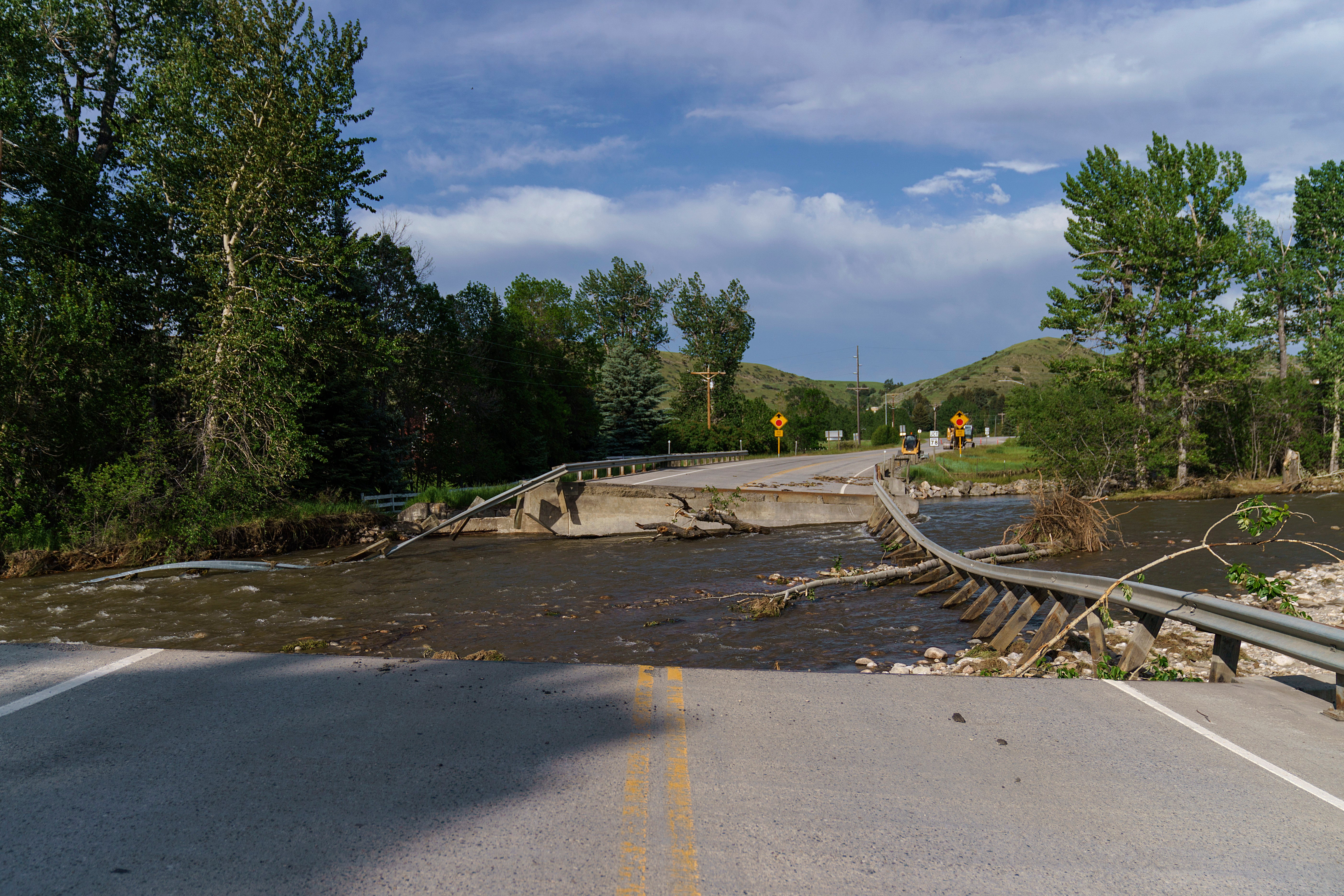 A river flows through a missing section of a key bridge that leads to the tourist town of Fishtail, Montana. Friday, June 17, 2022. (Photo: David Goldman,   (AP))
