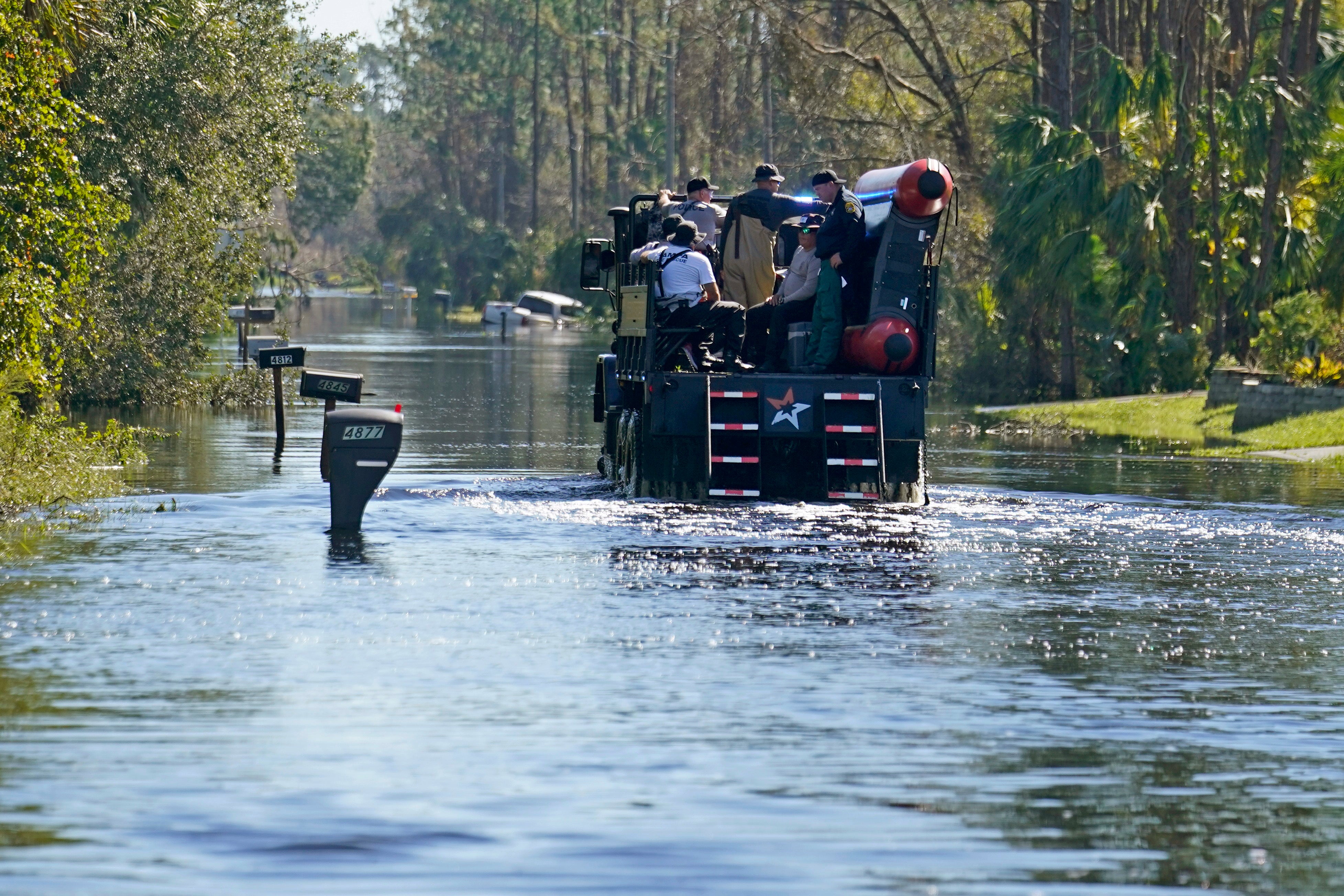 A high water vehicle with responders drives through a flooded neighbourhood in the aftermath of Hurricane Ian in North Port, Florida, Monday, Oct. 3, 2022 (Photo: Gerald Herbert, AP)