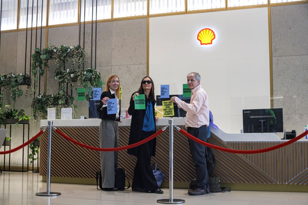Extinction Rebellion activists are seen with their hands glued to the reception desk of the Shell Building on April 13, 2022 in London, England. (Photo: Rob Pinney, Getty Images)