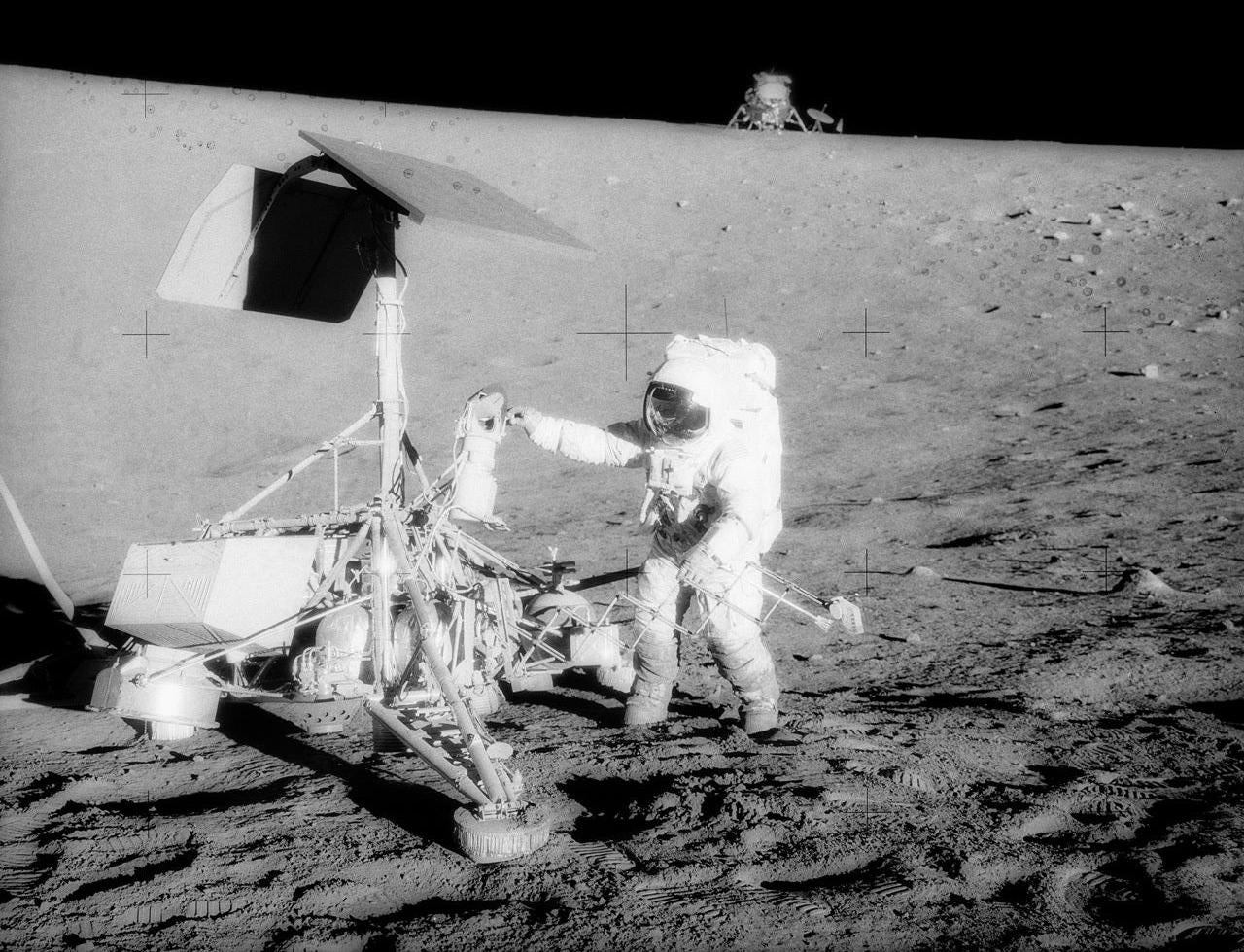 An Apollo 12 astronaut visiting Surveyor 3. (Photo: NASA)