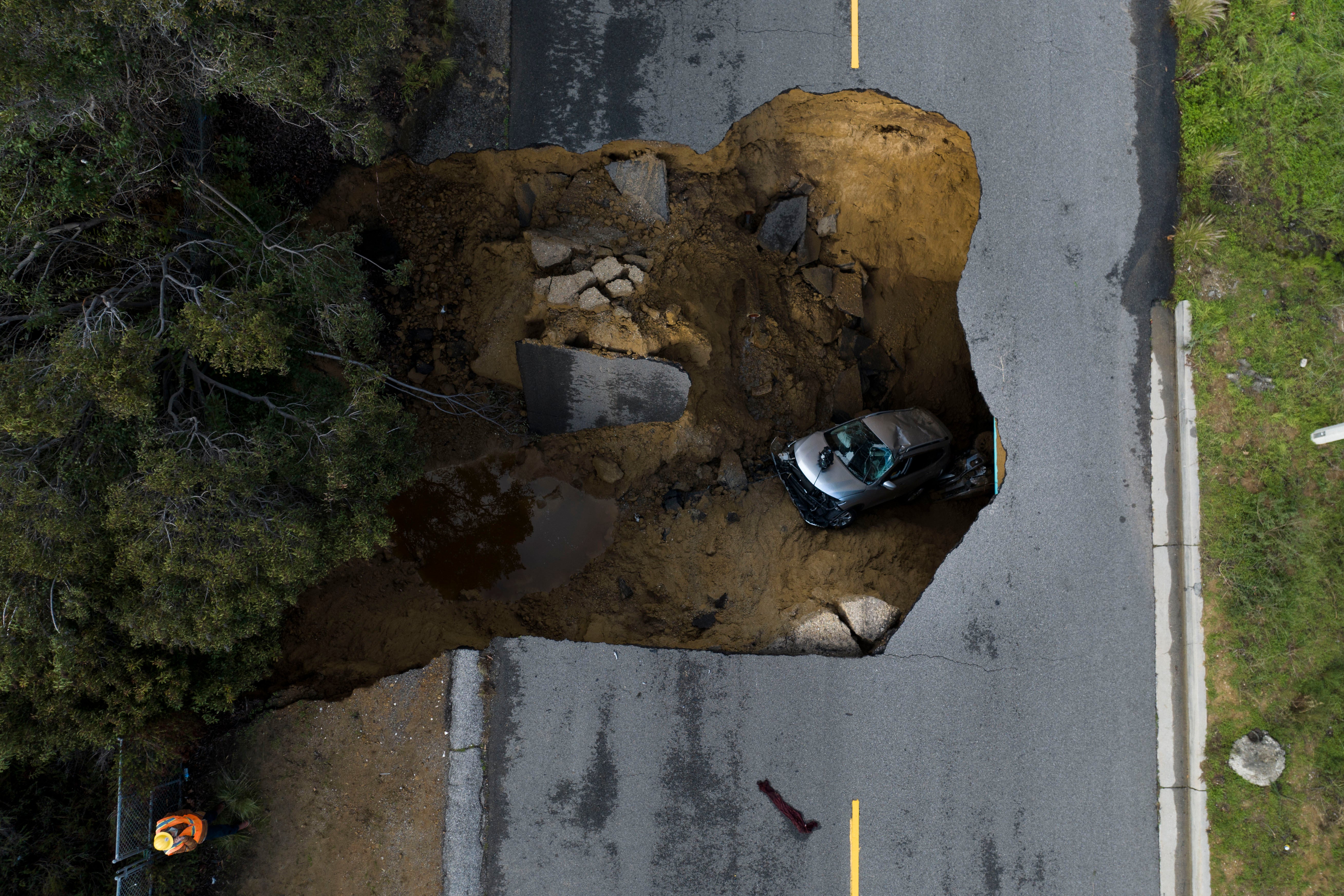 A car in a sinkhole in Los Angeles on Tuesday, January 10. (Photo: Jae C. Hong, AP)