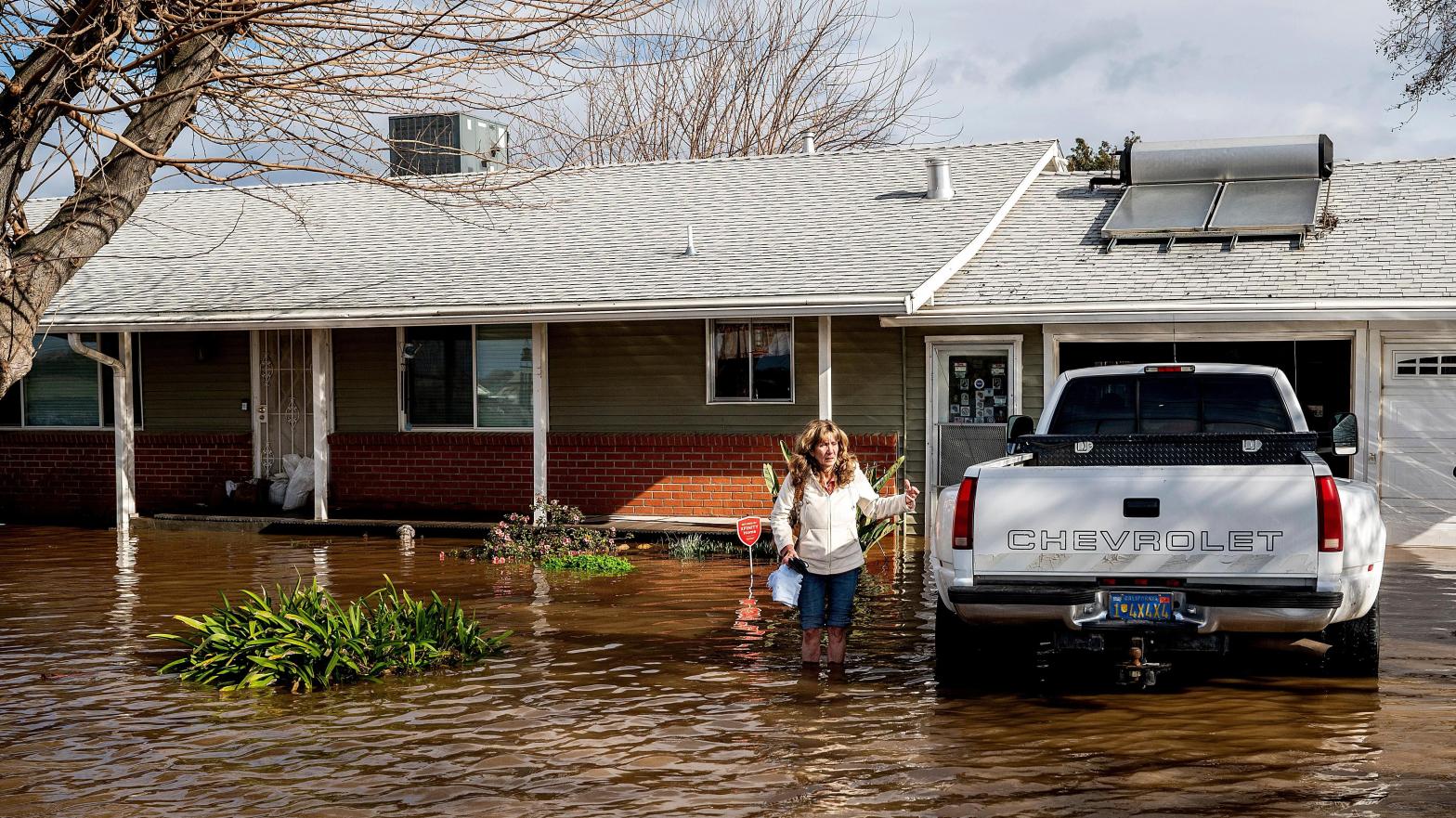 Kim Ochoa outside her flooded home in Merced, California on Tuesday, January 10. (Photo: Noah Berger, AP)