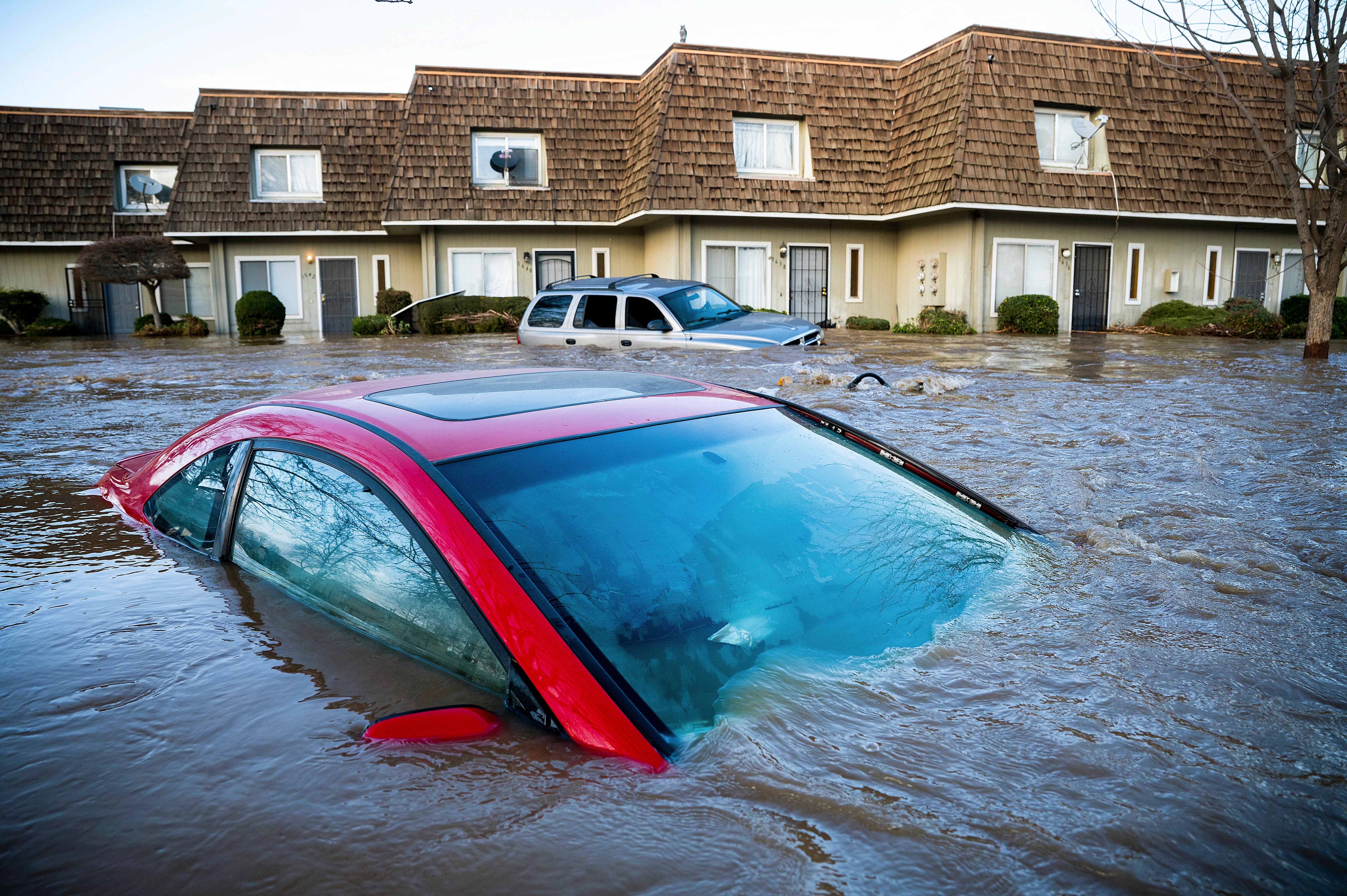 Floodwaters submerge a car in Merced. (Photo: Noah Berger, AP)