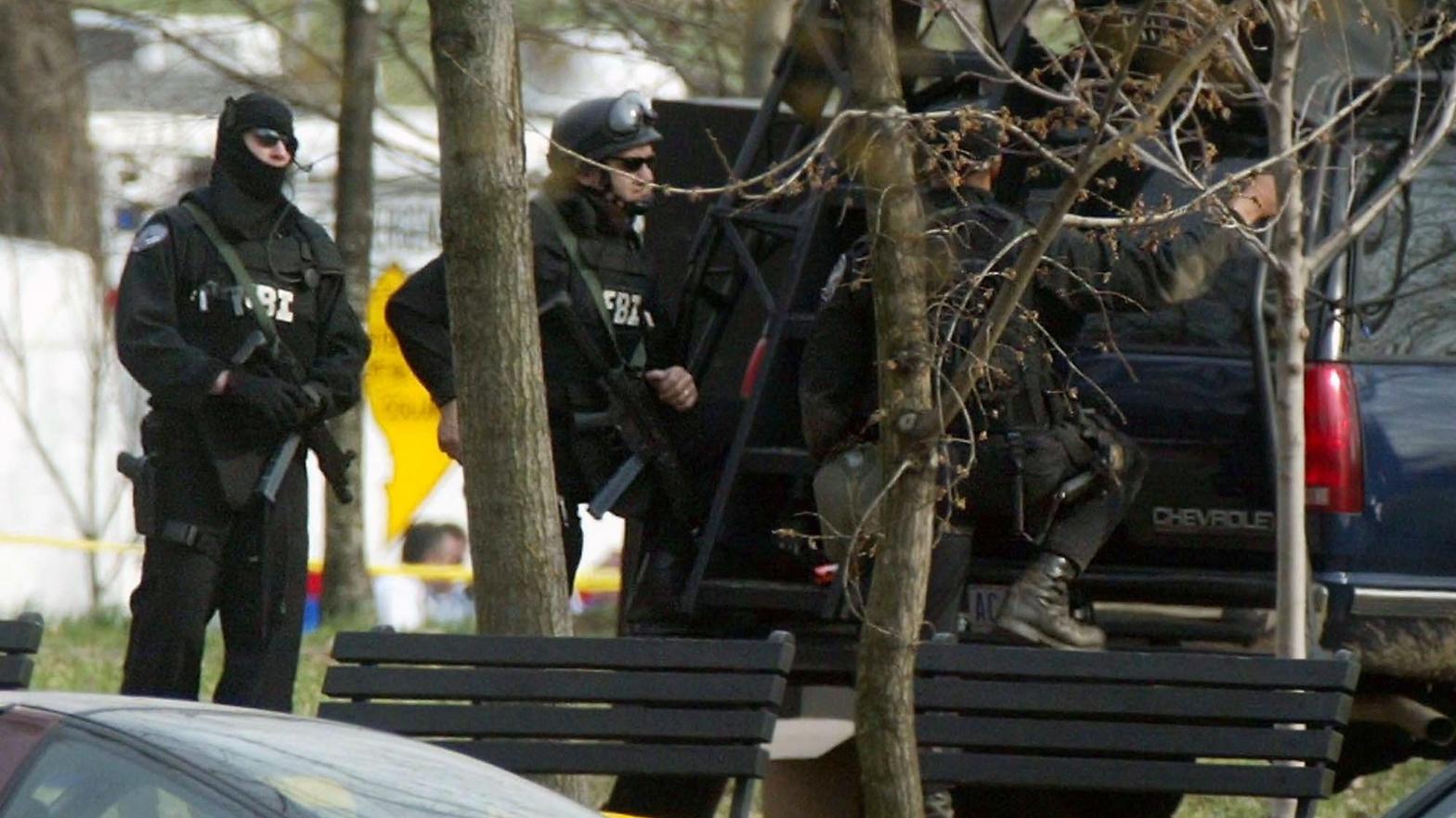 FBI agents with combat gear stand by a vehicle during a standoff with Dwight Watson, a former military policeman of North Carolina, who drove his tractor into a pond at the National Mall March 18, 2003 in Washington, DC (Photo: Alex Wong, Getty Images)