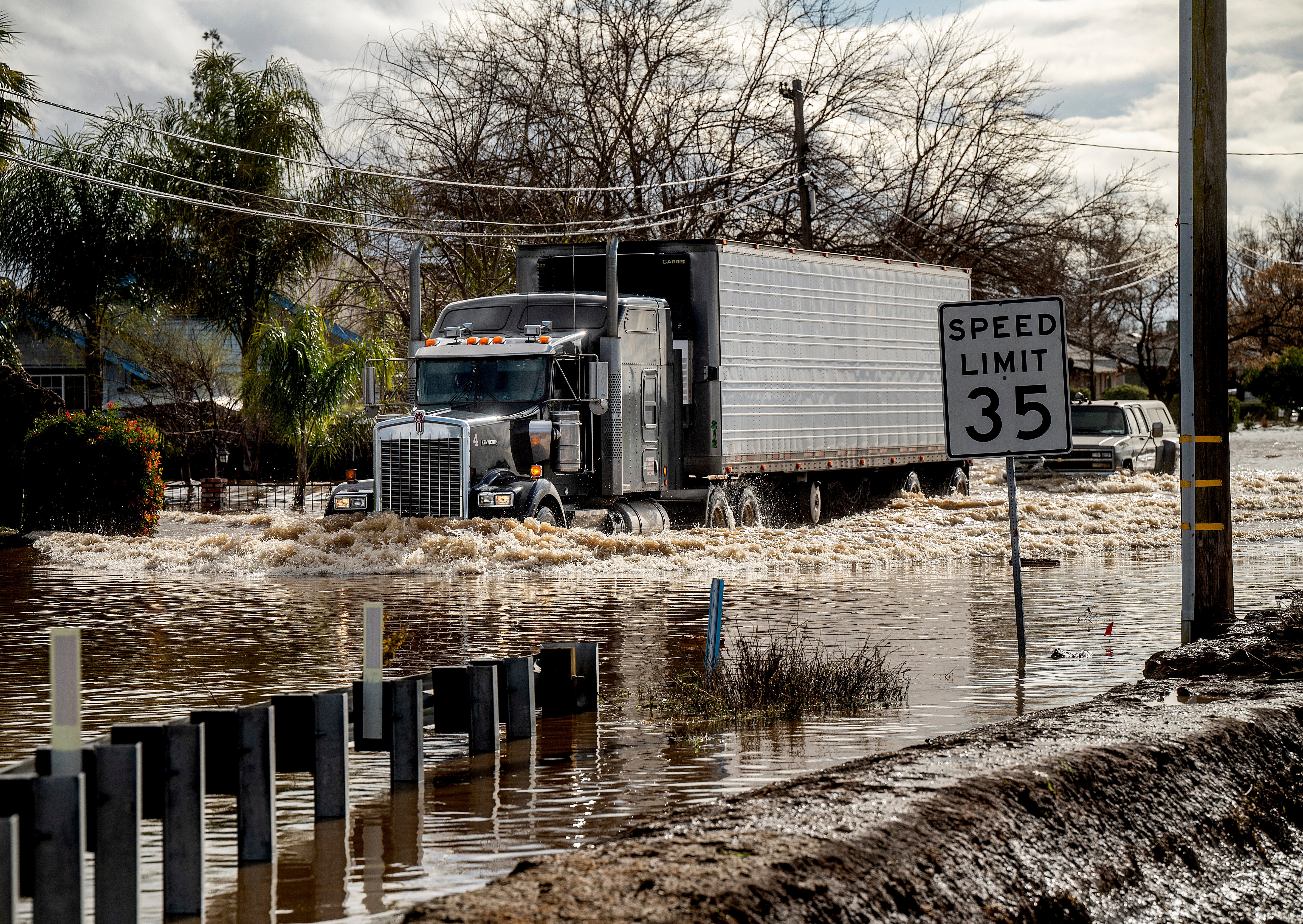 A truck drives through floodwaters in Merced. (Photo: Noah Berger, AP)