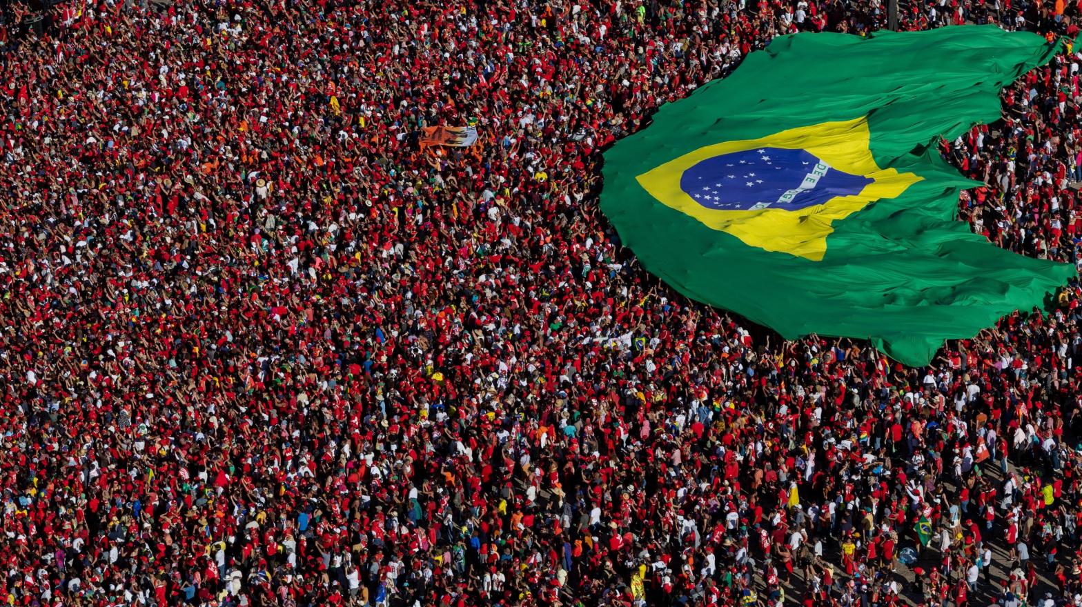 Supporters of President Luiz Inácio Lula Da Silva display a Brazilian flag during the presidential inauguration ceremony at Planalto Palace on January 1, 2023 in Brasilia, Brazil. (Photo: Myke Sena, Getty Images)