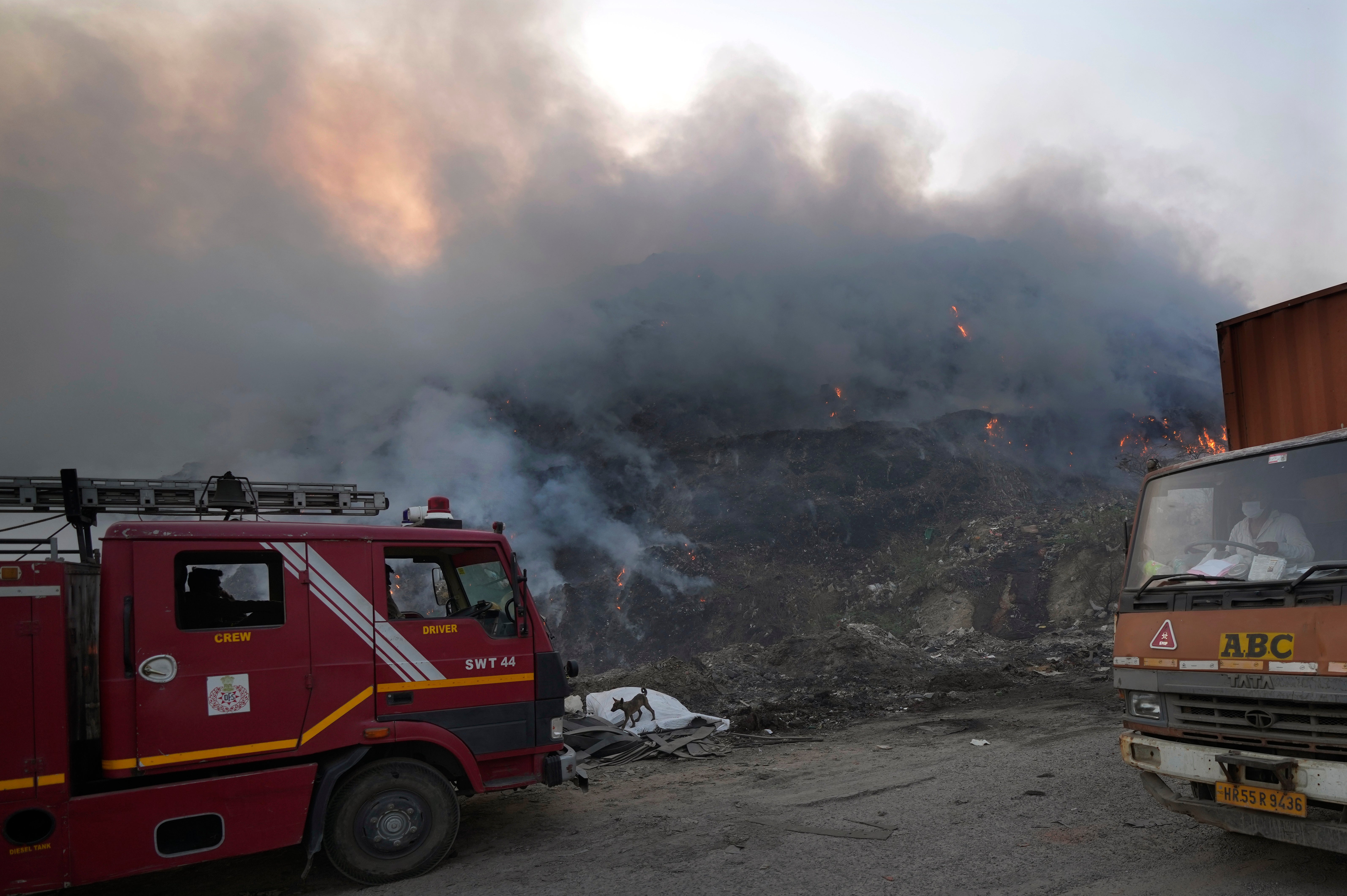 A Delhi fire tender waits during a fire at the Bhalswa landfill in New Delhi, India, Wednesday, April 27, 2022. (Photo: Manish Swarup, AP)