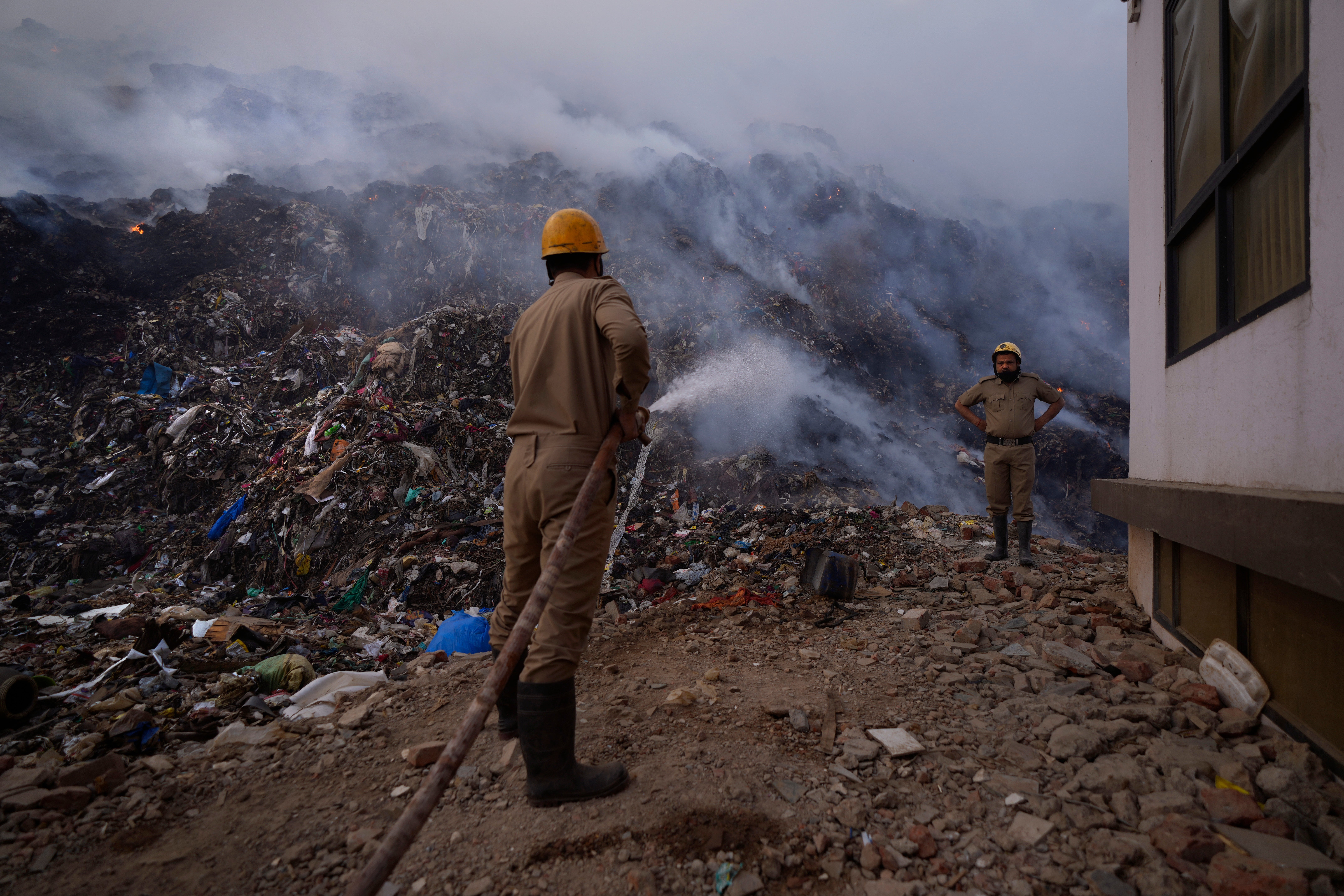 Fire officials try to douse a fire at the Bhalswa landfill in New Delhi, India, Wednesday, April 27, 2022. (Photo: Manish Swarup, AP)