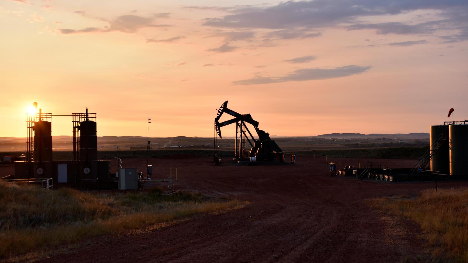 An oil well works at sunrise Aug. 25, 2021, in Watford City, N.D., part of McKenzie County. (Photo: Matthew Brown, AP)