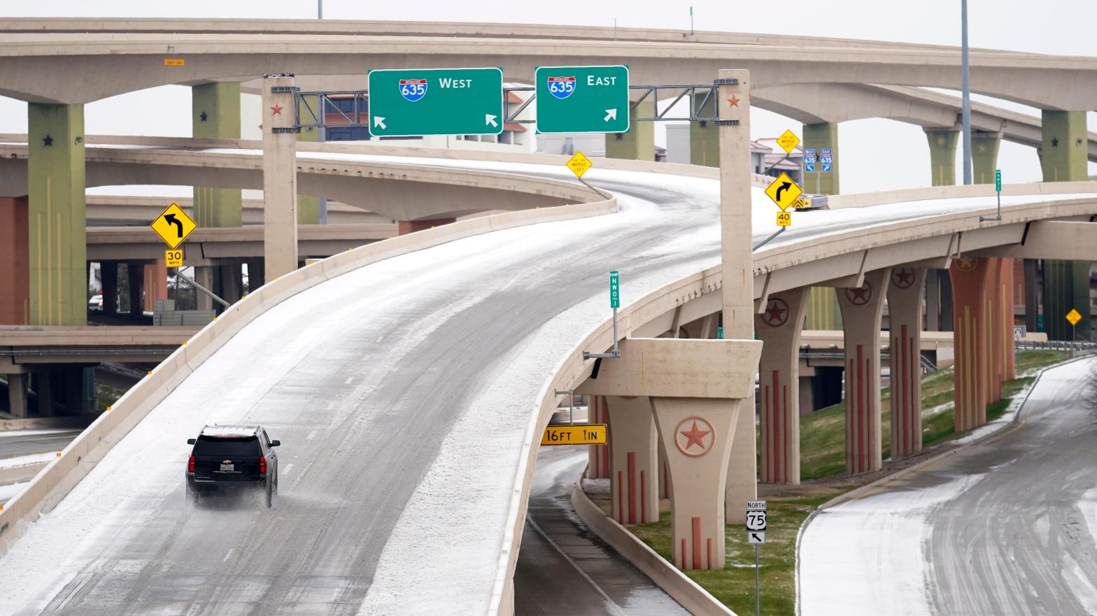 A driver slowly navigates through icy road conditions on the US 75 highway and LBJ 635 interchange Tuesday, Jan. 31, 2023, in Dallas. (Photo: Tony Gutierrez, AP)