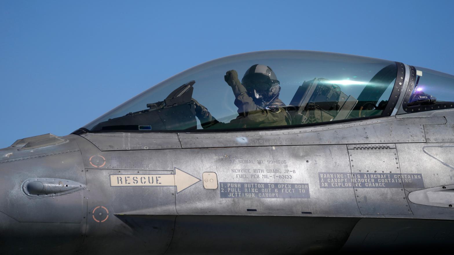 The pilot of a Greek Fighter Jet F-16 Viper salutes prior to takeoff.  (Photo: Thanassis Stavrakis, AP)