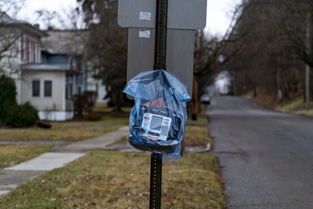 An air quality monitor hangs on a stop sign near the site of the train derailment.  (Photo: Michael Swensen, Getty Images)