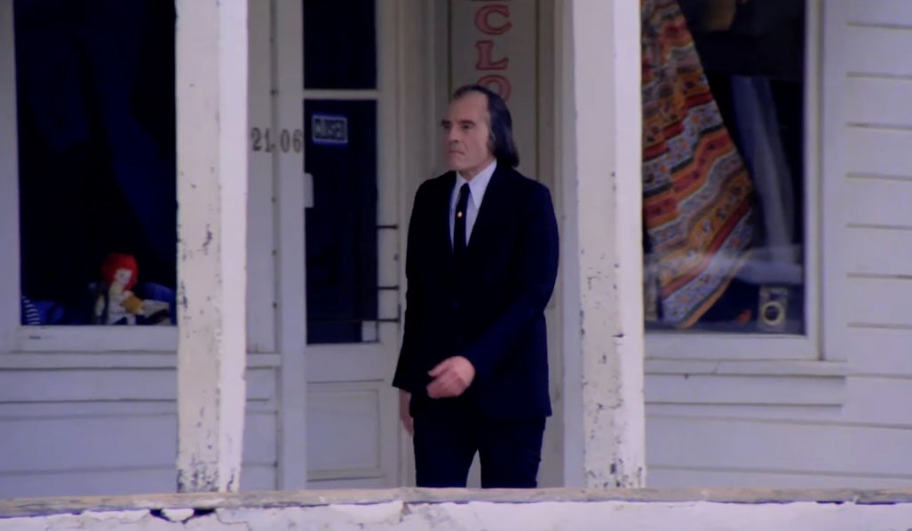The late, great Angus Scrimm as the Tall Man in Phantasm, terrifying even while just strolling around town. (Screenshot: AVCO Embassy Pictures)