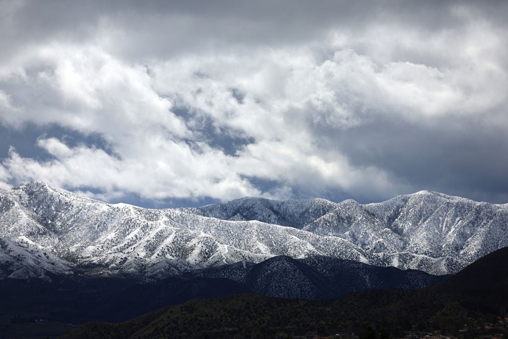 Storm clouds pass over snow-covered mountains in Los Angeles County during another winter storm in Southern California on March 01, 2023 near Acton, California.  (Photo: Mario Tama, Getty Images)