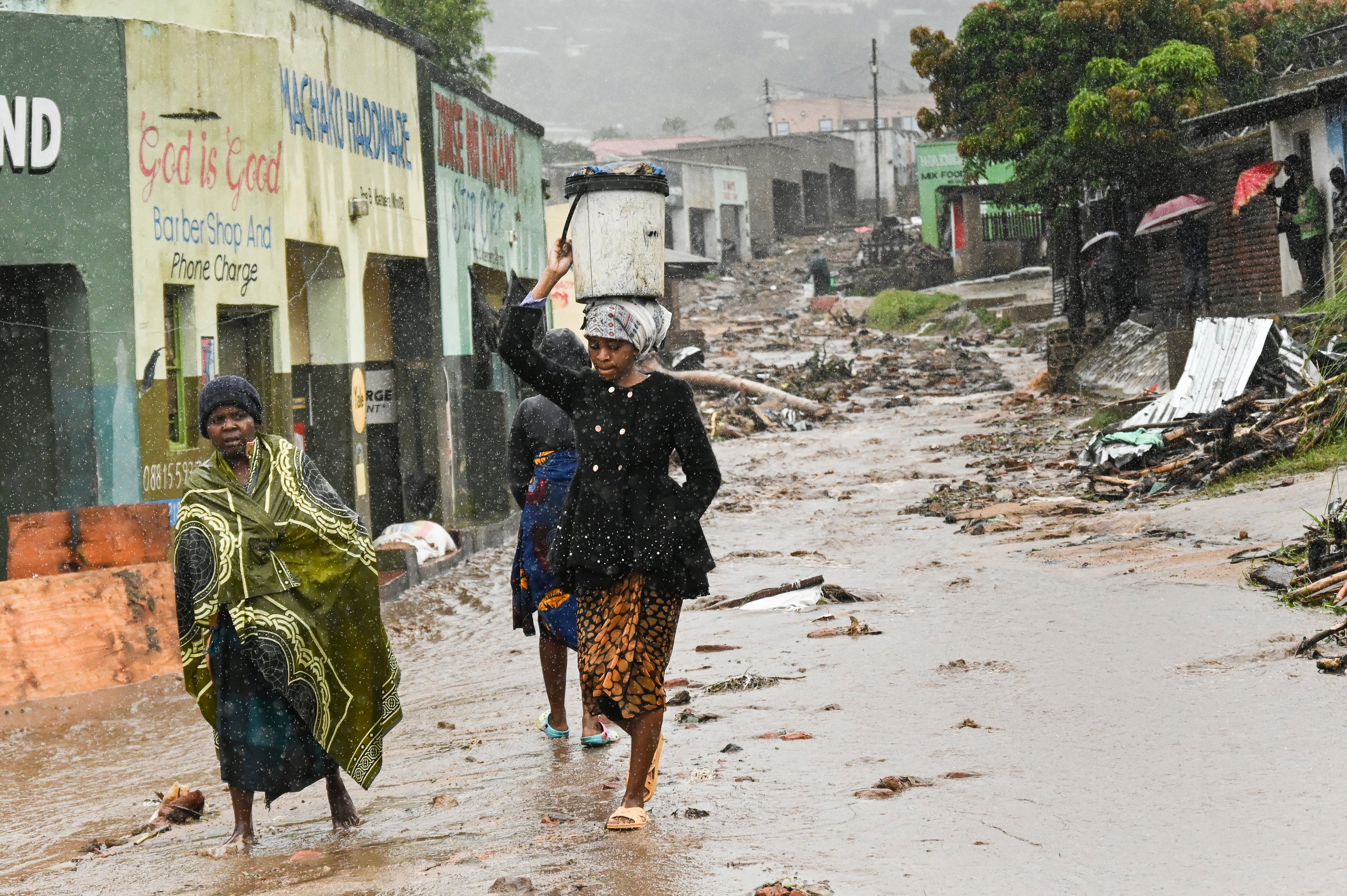 Women walk down a street in Blantyre after the storm. (Photo: Thoko Chikondi, AP)