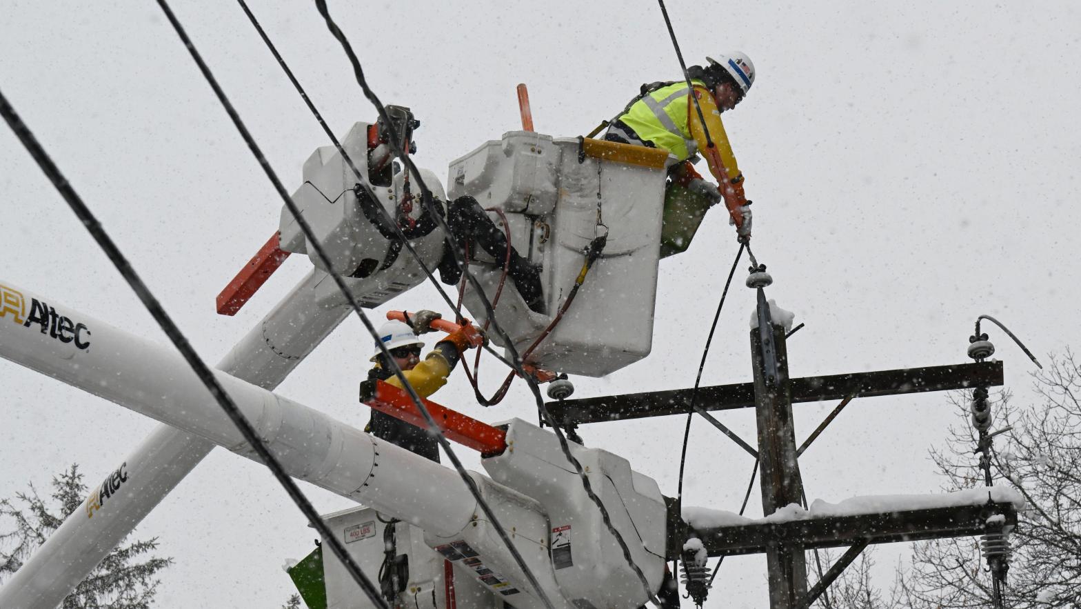 Workers fix a utility line Tuesday in Ballston Lake, New York. (Photo: Hans Pennink, AP)