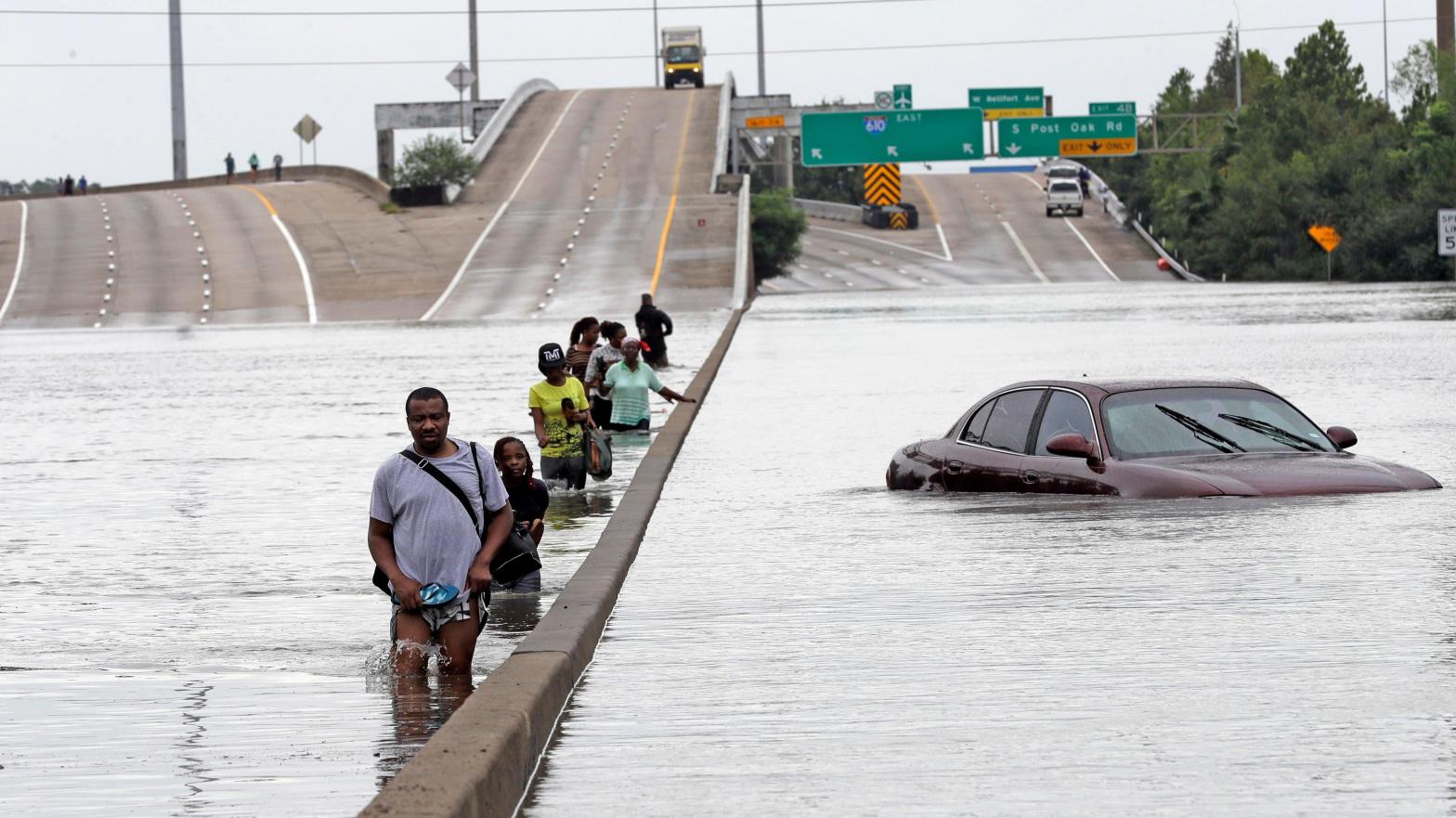 Evacuees wade through floodwaters after Hurricane Harvey in August of 2017.  (Photo: David J. Phillip, File, AP)