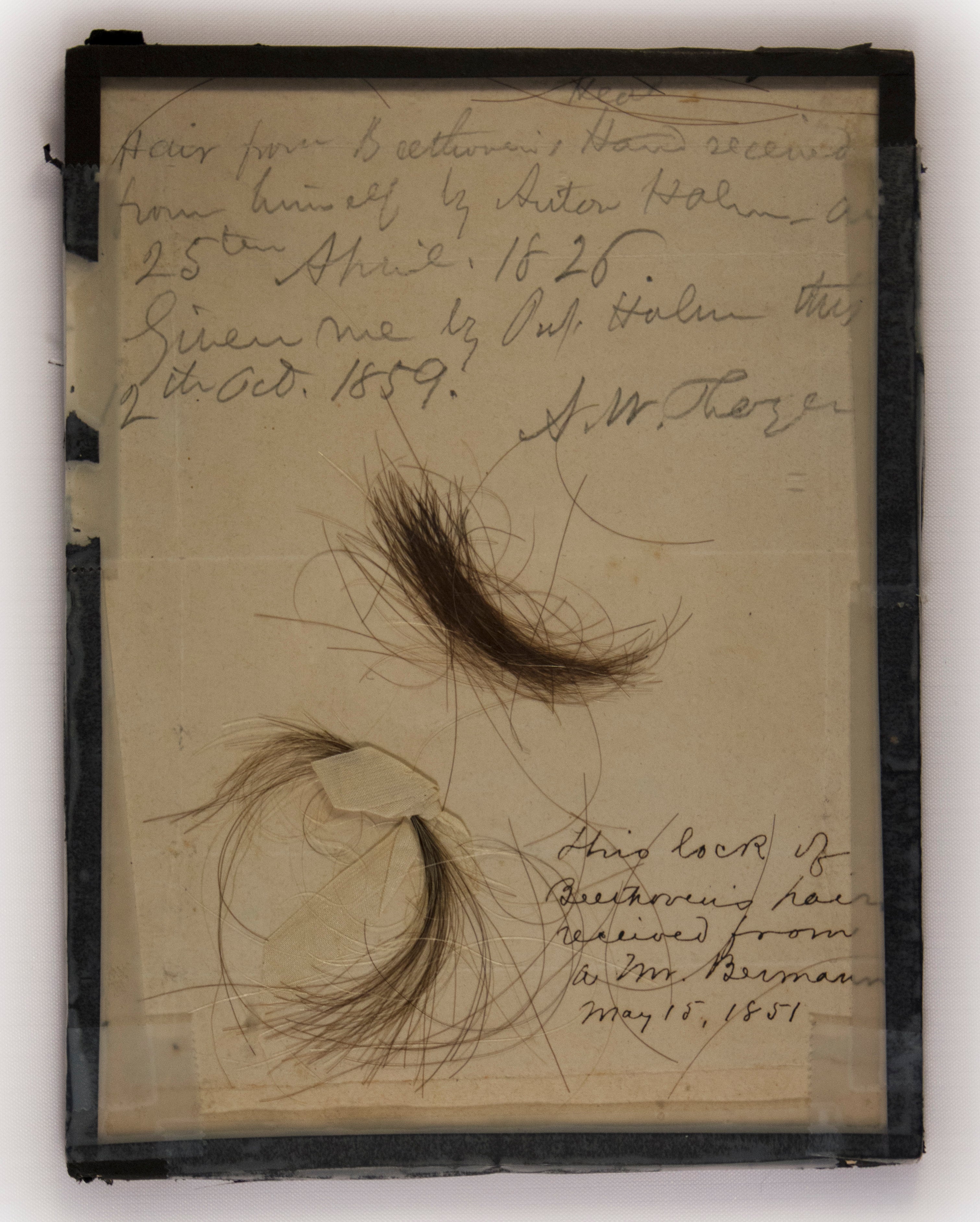 The two locks of hair, with inscriptions discussing their acquisition. (Photo: Kevin Brown)