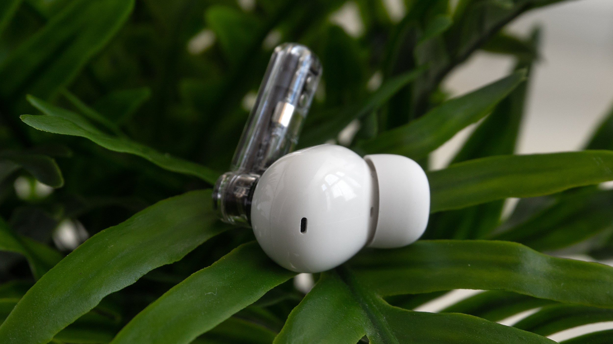 The Nothing Ear (2) earbuds are nearly identical to the Ear (1)'s, aside from a different label, and the location of one of the microphones. (Photo: Andrew Liszewski | Gizmodo)
