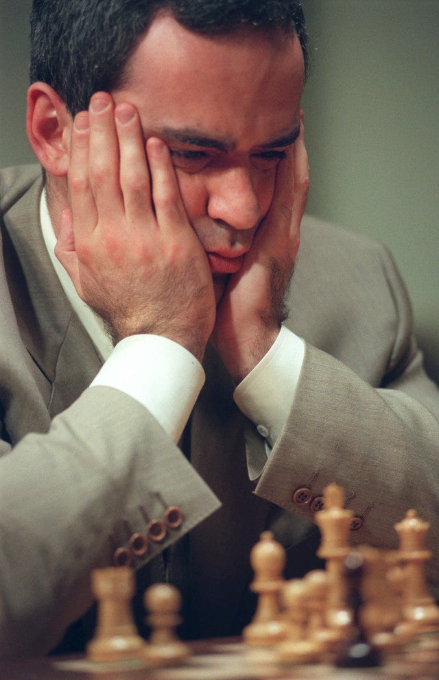World chess champion Garry Kasparov walks around the playing room as he  waits for IBM's Deep Blue chess playing computer to make its next move  during the third game of their six