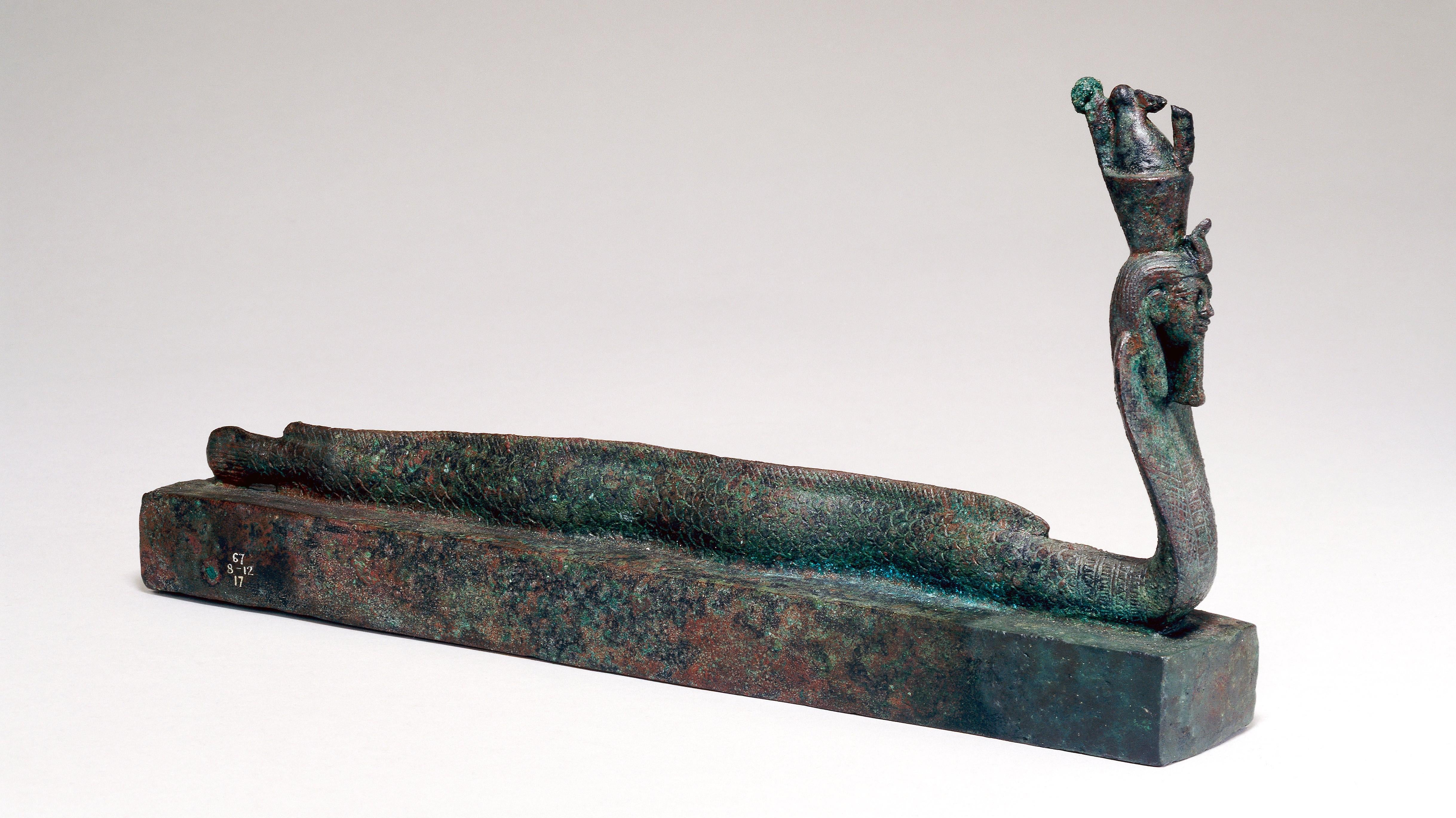 A box topped with a human-headed eel-cobra figure. (Image: The Trustees of the British Museum)
