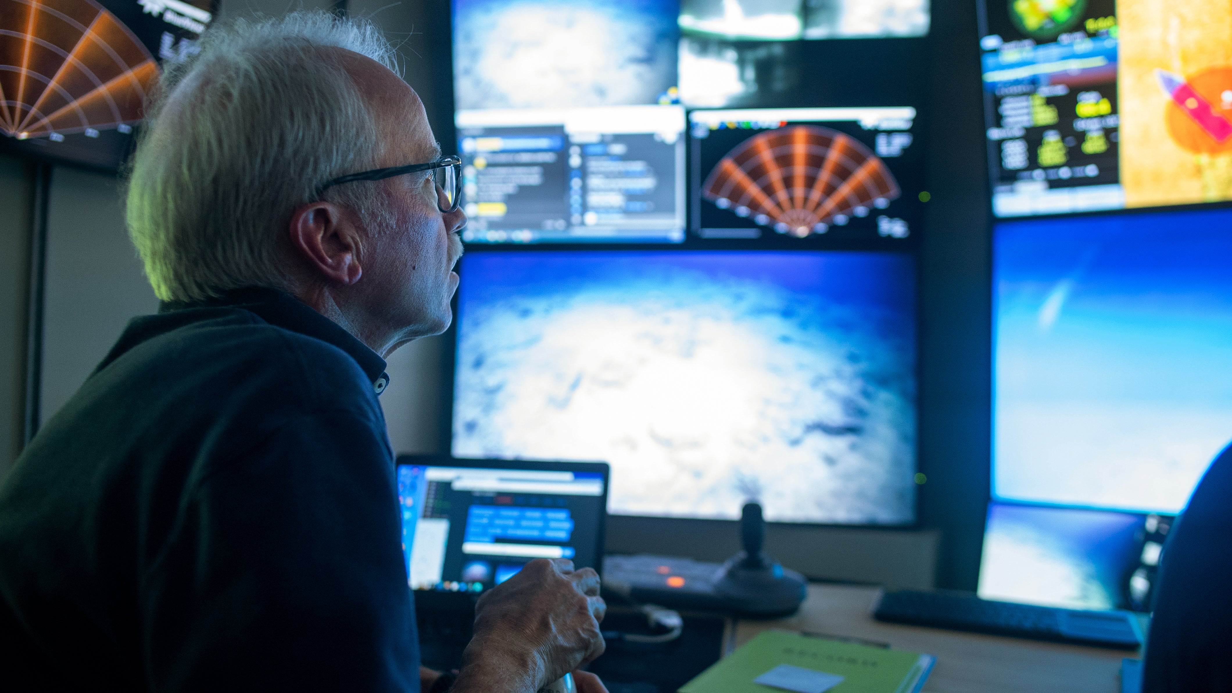 David Butterfield of the University of Washington looks at video feeds coming in from the ROV.  (Photo: Mónika Naranjo-Shepherd / Schmidt Ocean Institute)