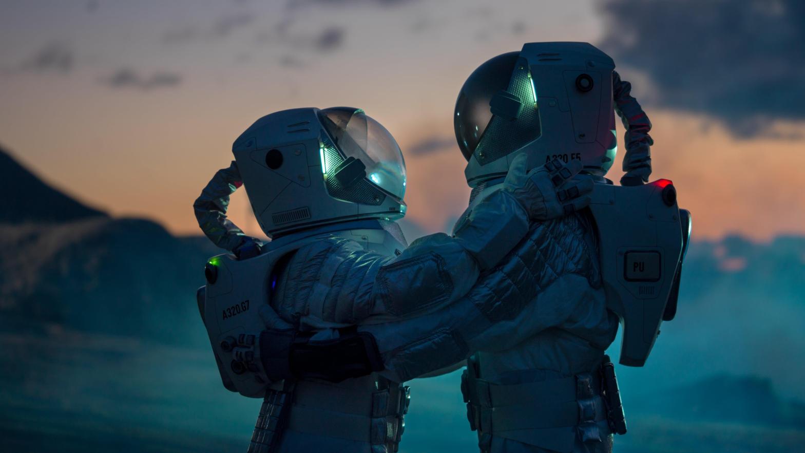 A conceptual image of two astronauts hugging on an alien planet. (Image: Gorodenkoff, Shutterstock)