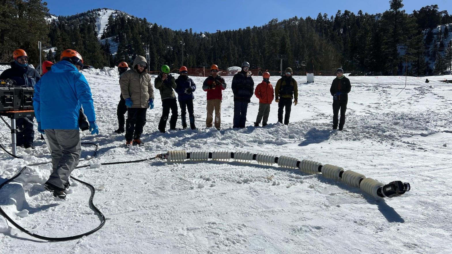 Team members testing out the snake robot named EELS at a ski resort in Southern California in February. (Photo: NASA/JPL-Caltech)