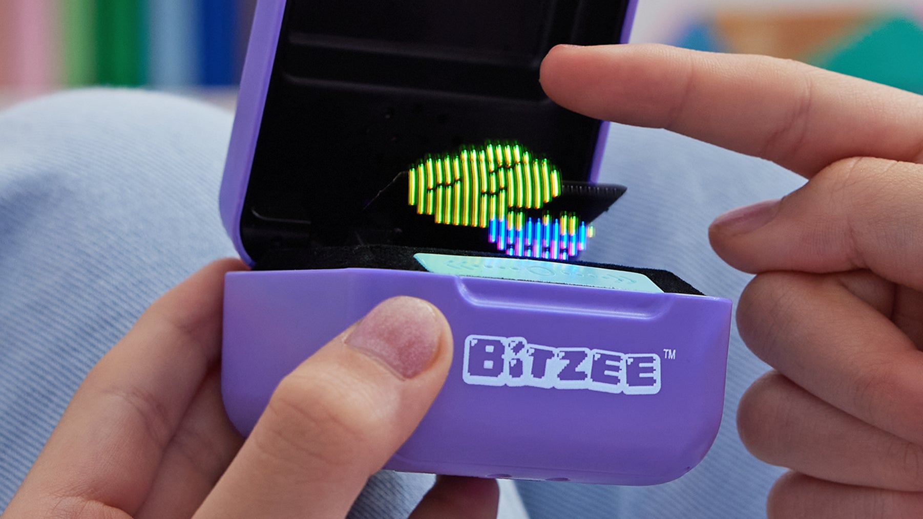 There are several ways to interact with the Bitzee digital pets, including shaking and tilting the device. (Image: Spin Master)