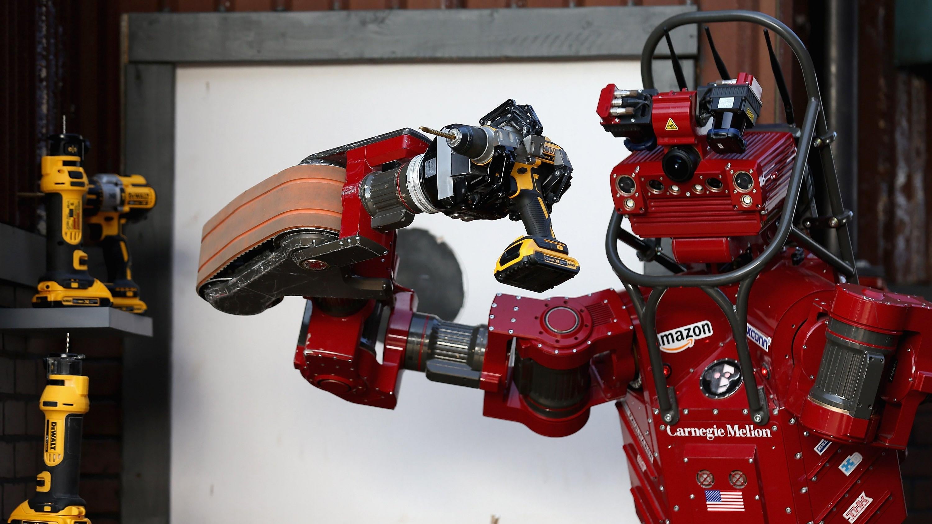 Team Tartan Rescue's CHIMP (CMU Highly Intelligent Mobile Platform) robot uses a hand-held power tool during the cutting task of the Defence Advanced Research Projects Agency (DARPA) Robotics Challenge at the Fairplex June 6, 2015 in Pomona, California. (Photo: Chip Somodevilla, Getty Images)
