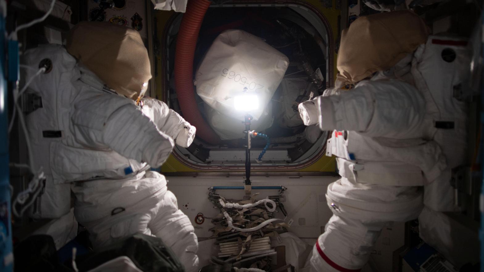 A pair of spacesuits inside the Quest airlock on board the ISS. (Photo: NASA)