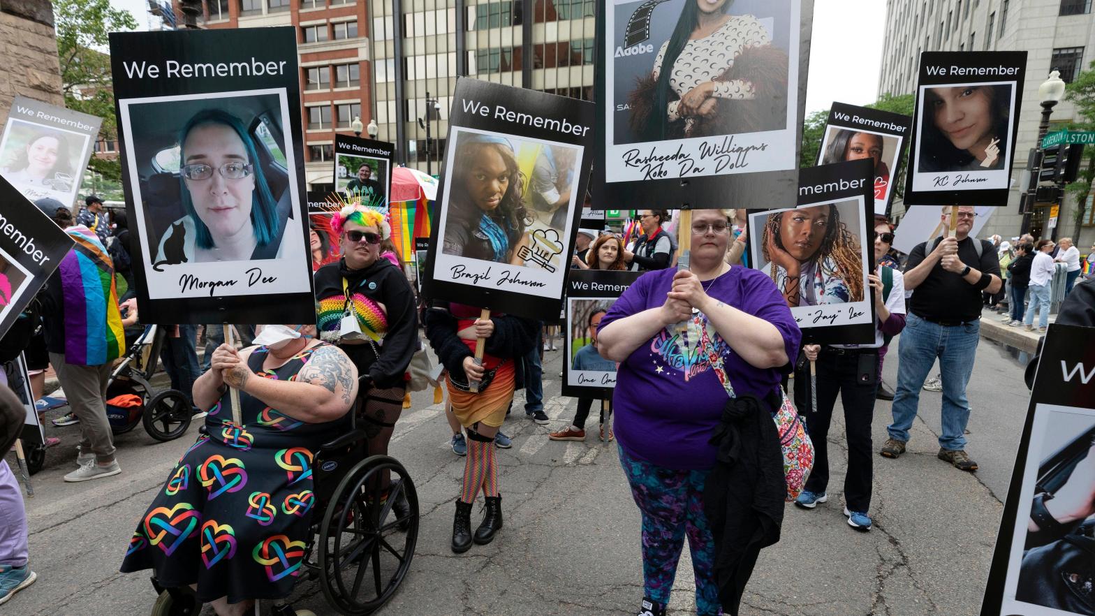 Marchers in the Boston Pride Parade held up photos memorializing members of the transgender community killed due to trans hate. (Photo: Michael Dwyer, AP)
