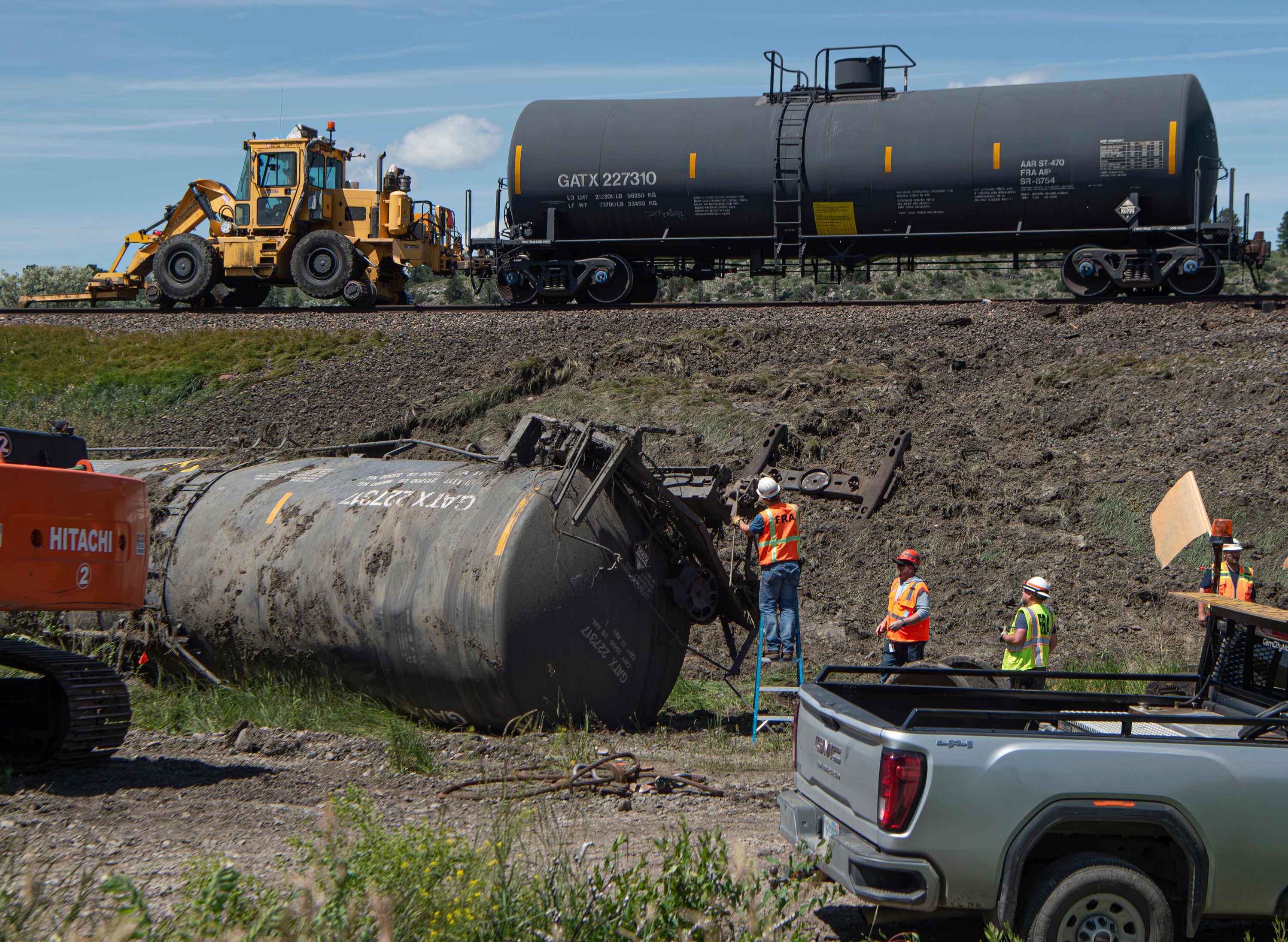 Crew members work on derailed cars at the site of a railroad bridge collapse on the Yellowstone River near Reed Point on Sunday, June 25, 2023, in Columbus, Montana.  (Photo: Amy Lynn Nelson/The Billings Gazette, AP)
