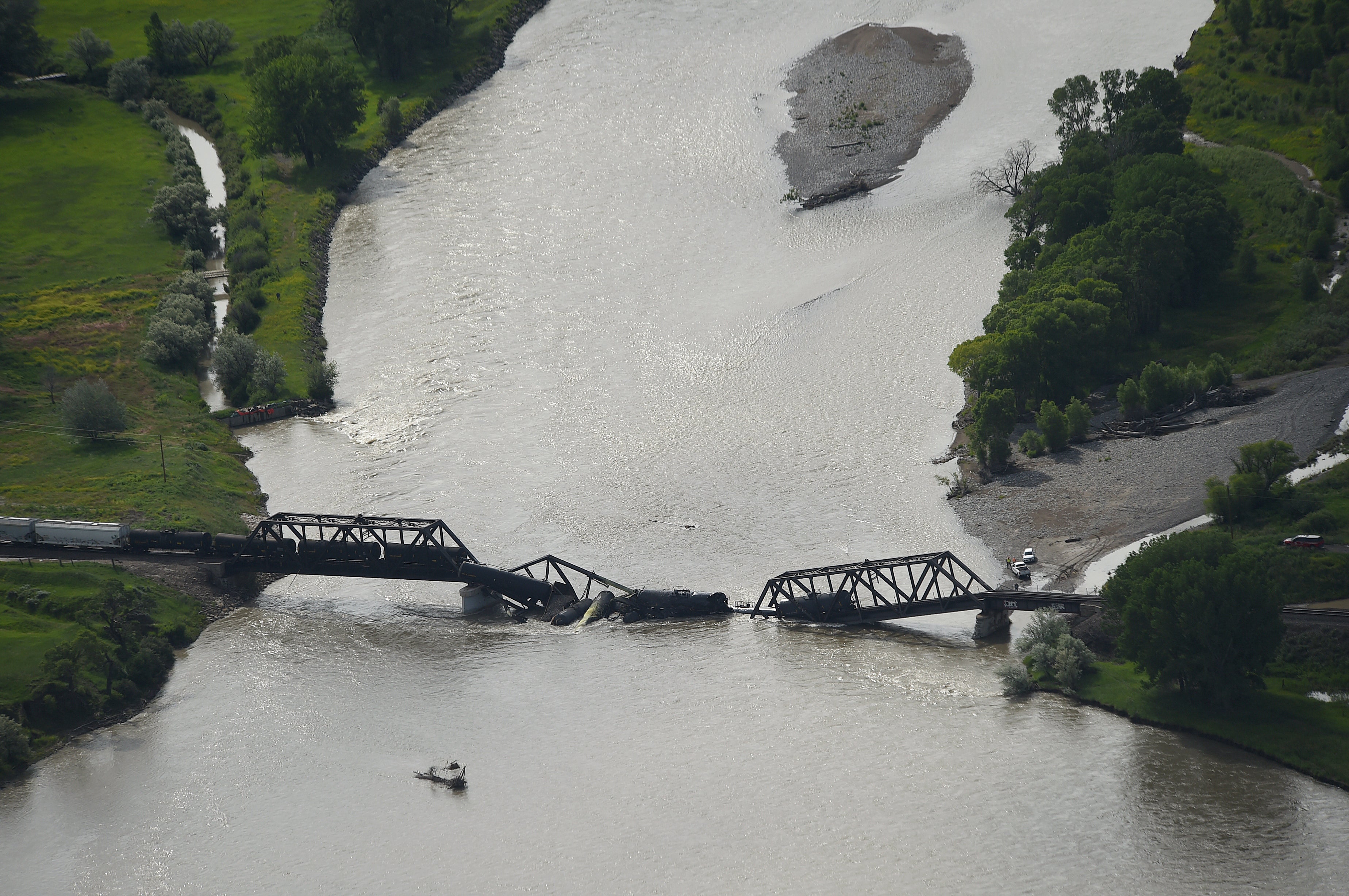 Portions of a freight train are seen in the Yellowstone River after an overnight railroad bridge collapse, near Columbus, Montana, on Saturday, June 24, 2023. (Photo: Larry Mayer/The Billings Gazette, AP)