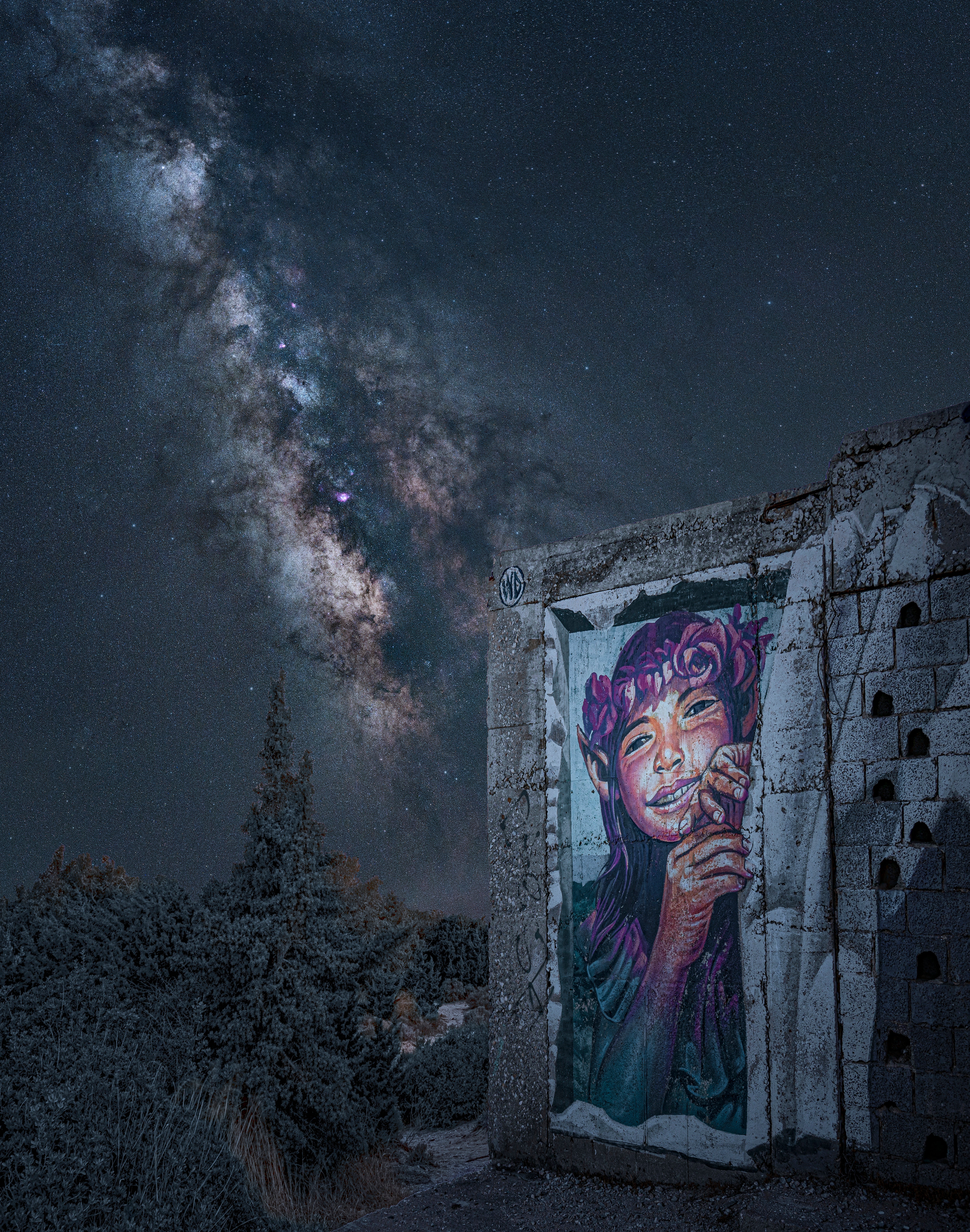 The Milky Way looms behind a graffito. (Photo: Derek Horlock)