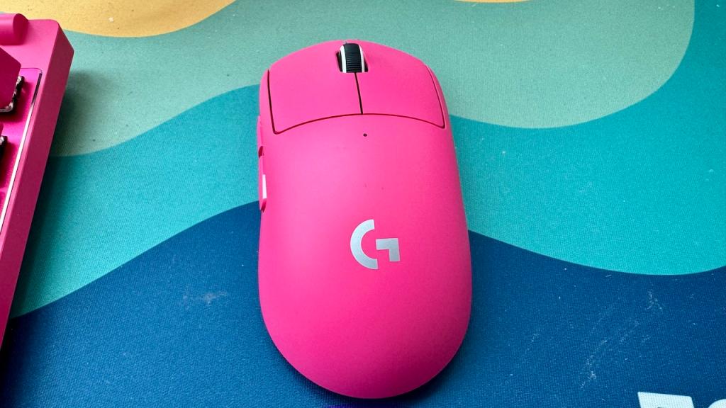 Pink Logitech G Pro X mouse on a rainbow mouse mat
