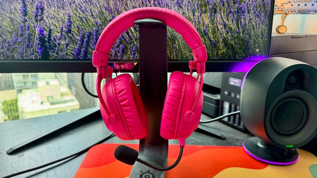 Pink Logitech G Pro X headphones in front of a PC