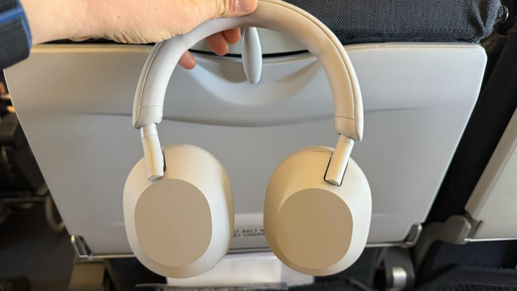 Holding up a bear of Sony headphones