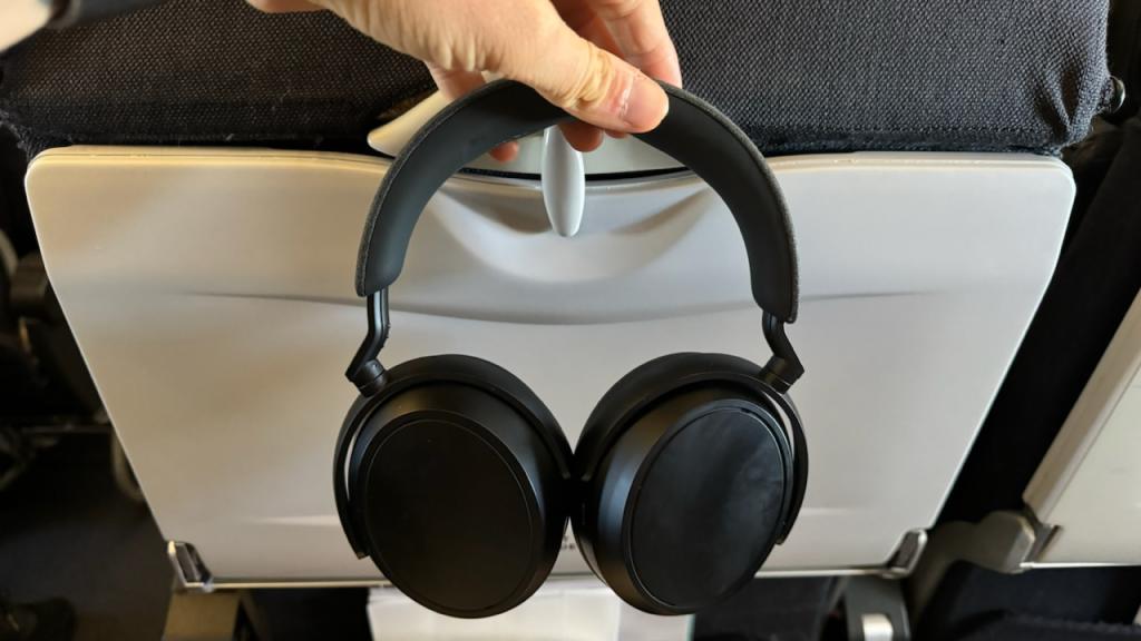 Holding up a pair of Sennheiser momentum headphones